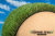 turf paradise 82 ounce artificial grass - green grass blades with tan thatch shown on a hatbox, with a blue sky background